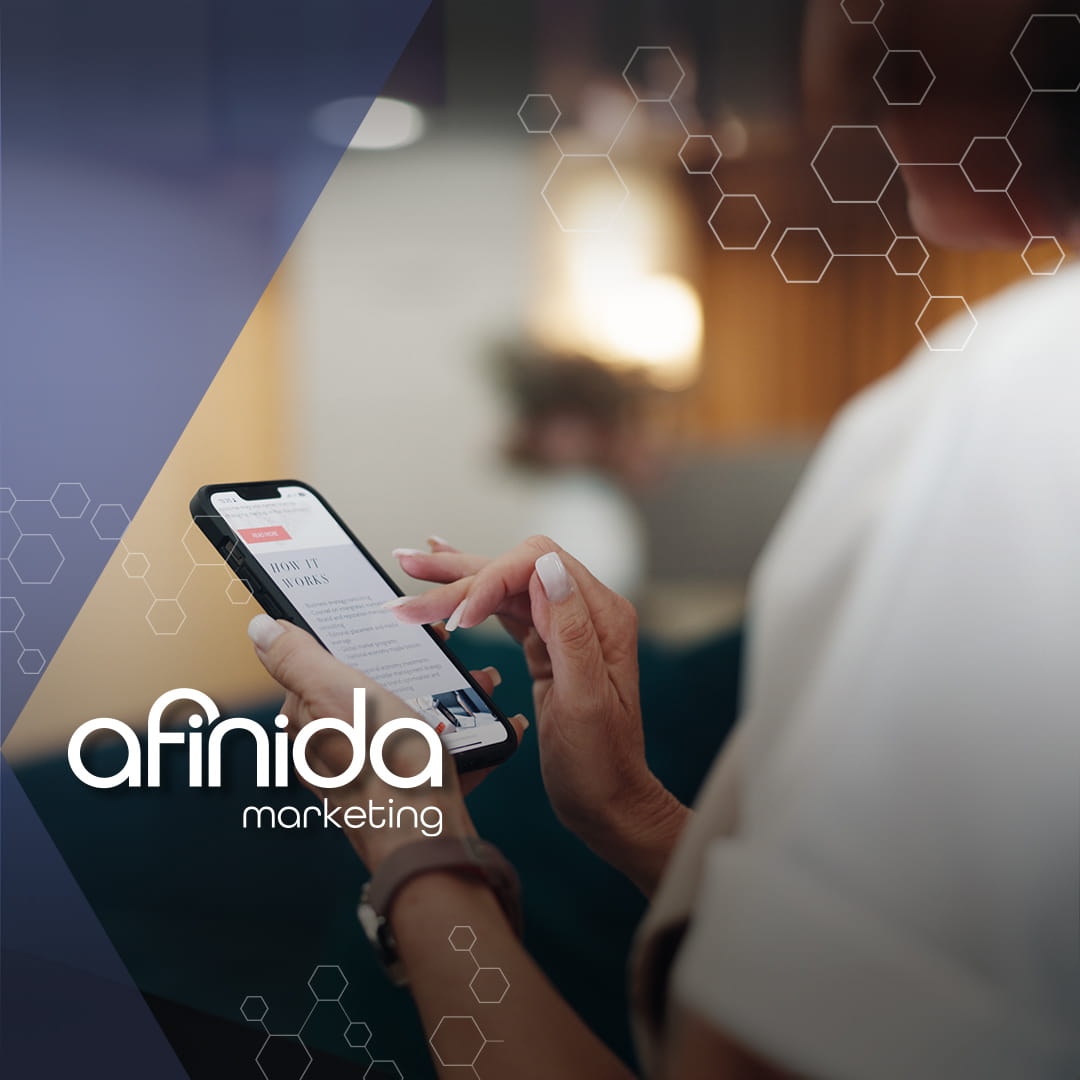 Person scrolling on a smartphone while reviewing a social media advertising strategy for paid campaigns and targeted ads.