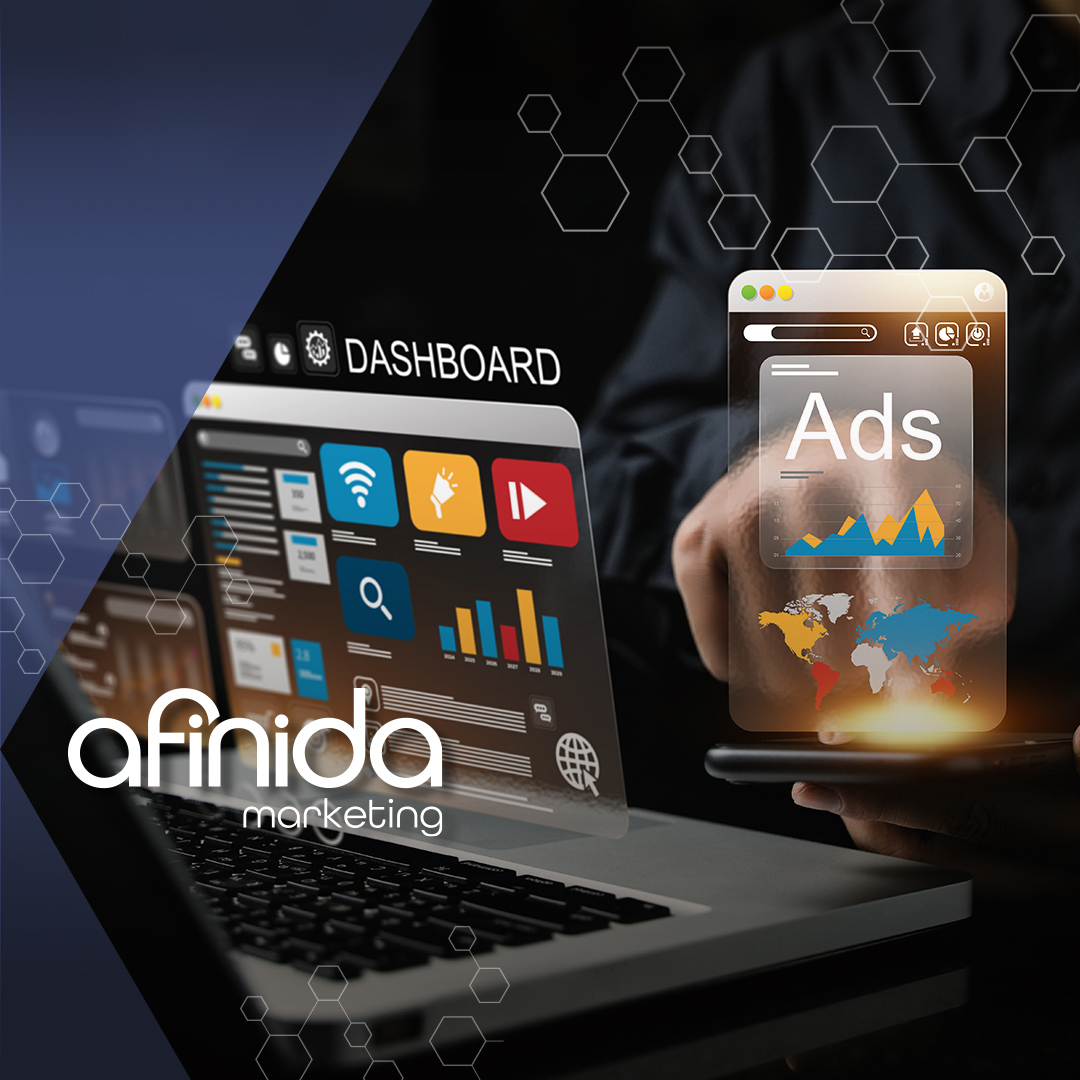 A professional working on a laptop and phone dashboard displaying digital advertising data and campaign metrics.