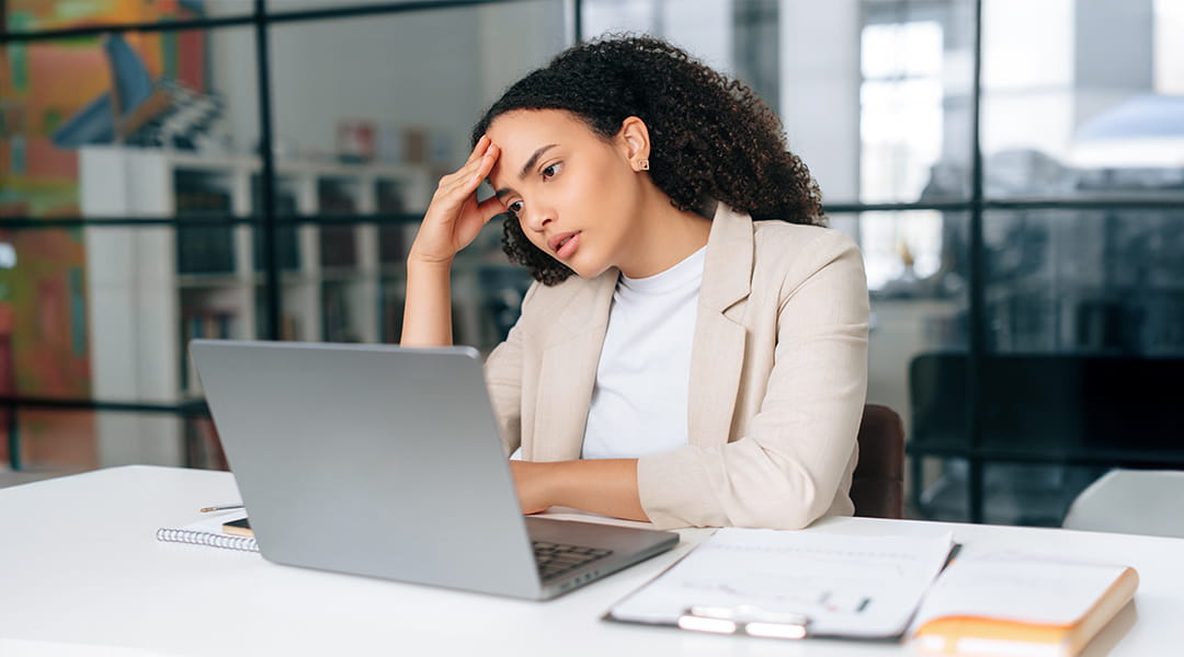 concerned Business professional reviewing campaign performance on laptop